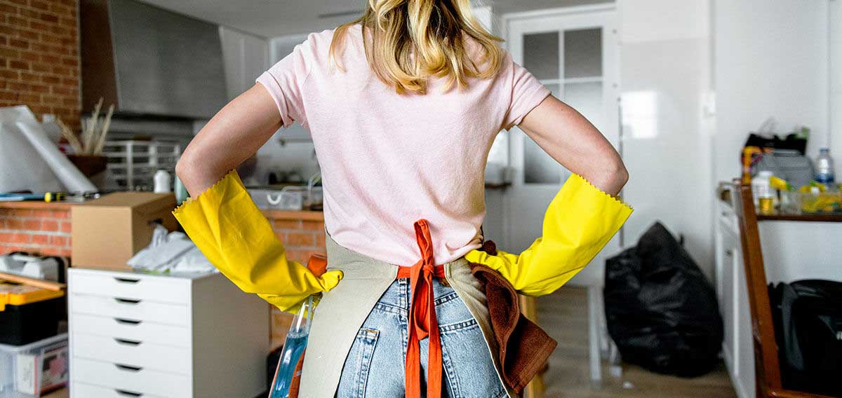 woman with hands on hips, ready to clean disorganized house