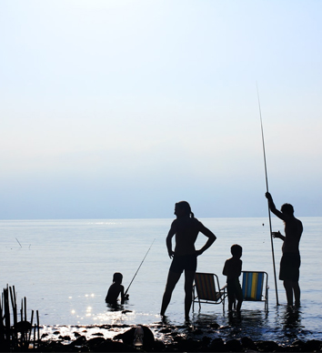 family fishing on a lake