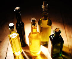 various oils in glass bottles with corks